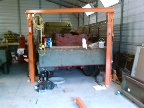 I used the bed of the CCKW to put the cross beam on the uprights.  No way one person is going to do it flat and lift the assembly into the air.  That's 500lbs of steel.